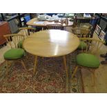 An Ercol ash dropleaf dining table 113cm wide, and a set of five ash spindle back dining chairs,