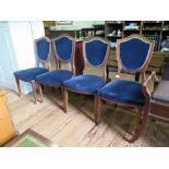 A set of four mahogany shield back dining chairs with blue upholstered backs and seats on square