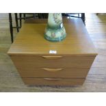 A small three drawer teak bedside chest of drawers (Europa furniture label inside)