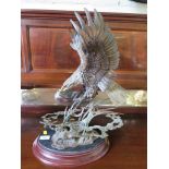 Dennis Jones (USA) 'Pride & Passion' - A bronze figure of a bald eagle catching a fish. On a