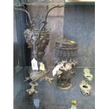 A bronze figure of a bird in a tree on frog form feet, 31cm high, two bronze oil lamps, a