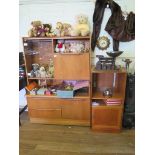 A small teak side cabinet, with glazed door and fall front above two drawers beside a cupboard