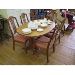 A Nathan teak crossbanded extending dining table and six chairs, including two carvers, table