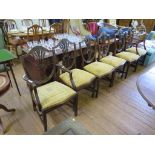 A set of six Hepplewhite style mahogany dining chairs with two carvers, the shield backs over drop