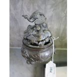 A Japanese bronze censer of squat form, the cover with a figure of a crane, on fruit feet, 16cm