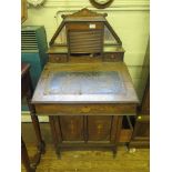 An Edwardian inlaid rosewood Davenport, the raised mirrored back with tambour front and drawers,