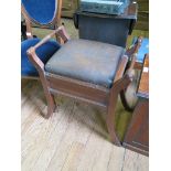 An Edwardian walnut piano stool, with hinged seat and outsplayed legs