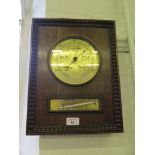 A 1930's rectangular oak barometer, with tongue and dart border, enclosing a brass dial and