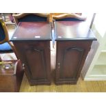 A pair of reproduction mahogany side cabinets with panelled doors, 34.5cm wide