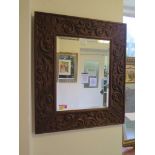 A carved oak rectangular wall mirror with bevelled plate and acanthus scroll carved border, 73cm x