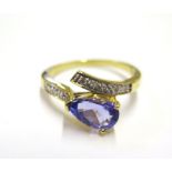 An 18 carat yellow gold ring set with a tanzanite and two rows of diamonds