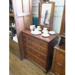 A George I style featherbanded walnut chest of drawers, surmounted by a swing mirror over four