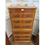 A crossbanded yewwood veneer miniature chest on chest with three drawers over three further