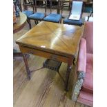 An Edwardian walnut envelope table, with frieze drawers on turned legs joined by a under shelf, 65cm