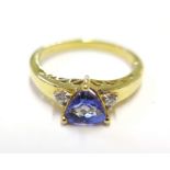 A tanzanite and diamond ring set in 9 carat yellow gold