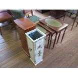 A nest of three crossbanded tables with leather inset tops and reeded legs, 55cm wide, a cream