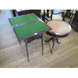 *A small mahogany foldover card table with undershelf and square tapering legs, 52cm, and a