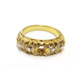 A four stone cushion cut diamond ring set in gold colour metal