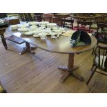 An oak twin pedestal dining table, with two extra leaves, on ring turned columns and quadruped