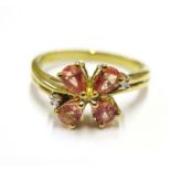 A celon padparadscha colour sapphire set in 9 carat yellow gold and diamond ring