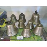 A set of eight bronze handbells