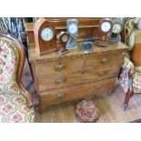 An early 19th century mahogany chest of drawers with two short and two long graduated drawers on