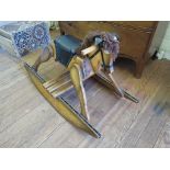 A small varnished pine rocking horse, 60cm high, 96cm long