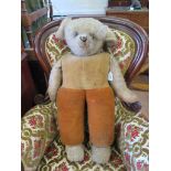 A Norah Wellings teddy bear, with yellow waistcoat and orange trousers, 70cm high