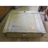 A pine sloping table top desk, the hinged lid enclosing compartments, 61cm wide