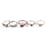 A collection of five silver and gem set rings