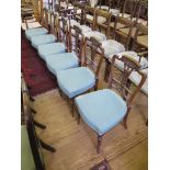 A set of six Edwardian walnut salon chairs, with carved vase shape splats on fluted turned