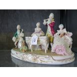 A pair of Volkstedt-Rudolstadt figure groups depicting musicians around a piano, on gilded bases,