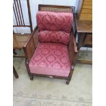 A 1920's mahogany bergere armchair, with cane back and arms on square tapering legs and spade feet