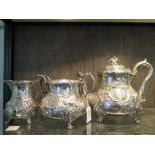 A Victorian three piece silver tea set in Rococo style on four feet, London 1850 Maker GI