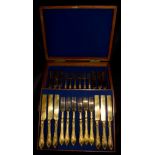 A canteen of gilded silver plated knives and forks for twelve place settings