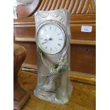 A pewter Art Nouveau table clock, of rectangular form with a lady holding aloft the dial, stamped