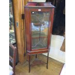An Edwardian mahogany and satinwood crossbanded corner cabinet, with astragal glazed door on