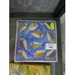 A Middle Eastern tile depicting fish, 15cm square