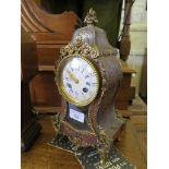 A 19th century French Boullework table clock, the shaped case with gilt metal mounts, the enamel
