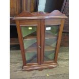 A mahogany hanging corner cupboard with shaped apron and twin glazed doors, 41cm wide, 66cm high