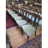 A set of six Edwardian stained beech salon chairs, with pierced shell carved splats on cabriole