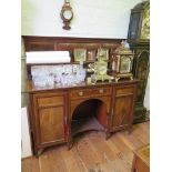 An Edwardian mahogany and satinwood crossbanded sideboard, the raised back with mirror panel and