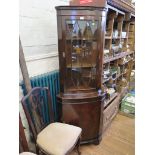 A reproduction mahogany corner cabinet, with glazed and cupboard doors, 65cm wide, 180cm high