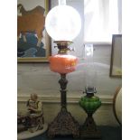 A 19th century gilt metal and copper oil lamp 76cm high and another (2)