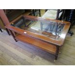 A cherrywood glass top coffee table, rectangular with turned supports and undershelf, 110cm wide