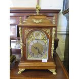 A late Victorian walnut and ormolu bracket clock, the flare finial over a caddy top above figural