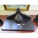 An ebonised wall bracket with lobed and shaped support, 50cm wide