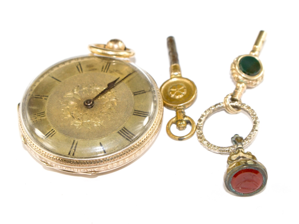 A ladies 14 carat gold fob watch with key and seal