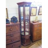An American reproduction display cabinet by Pulaski Furniture Corporation, with bevelled glass
