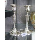 A pair of Adam style silver plated candlesticks